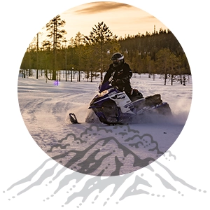 A person riding a snowmobile in the winter at Grand Lake Colorado